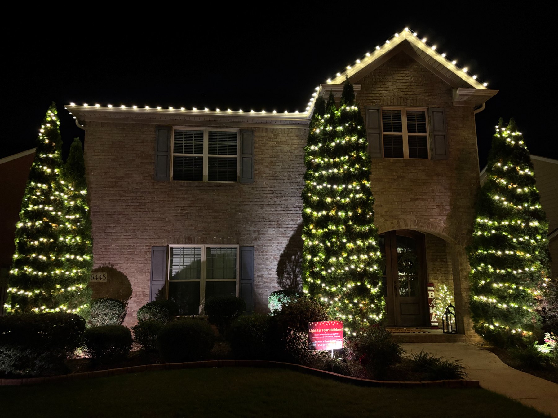Roofline Christmas lights with wrapped trees